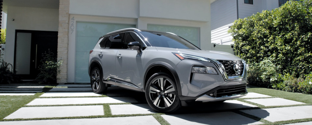 A grey 2022 Nissan Rogue is parked in a driveway.
