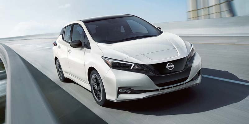 A trim level option of a 2024 Nissan LEAF driving down a highway in Medina, OH