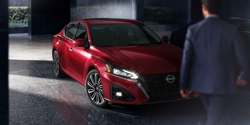 A man walking toward a stylish 2024 Nissan Altima in Medina, OH