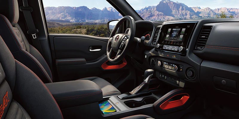 The interior front seat of the 2024 Nisan Frontier in Medina, OH