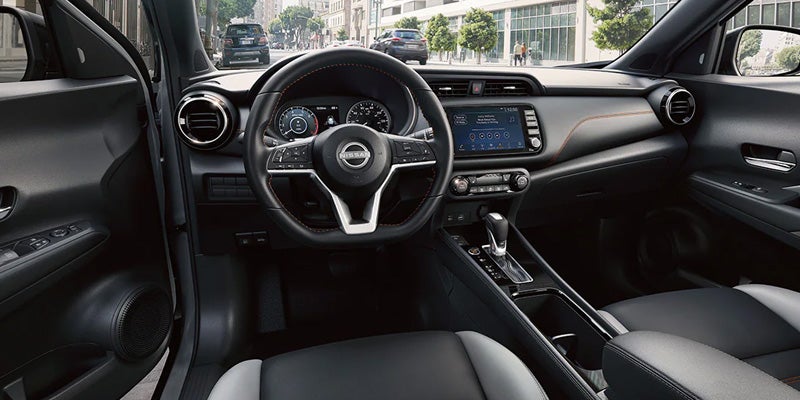 The view of a steering wheel from the driver's seat in the 2024 Nissan Kicks in Medina, OH