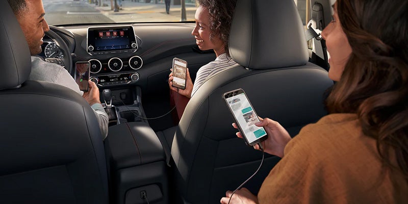 A backseat passenger changing the music on a 2024 Nissan Sentra in Medina, OH