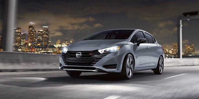 A 2024 Nissan Versa driving on a city highway with its powerful performance in Medina, OH